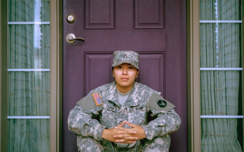 woman sitting in front of closed door