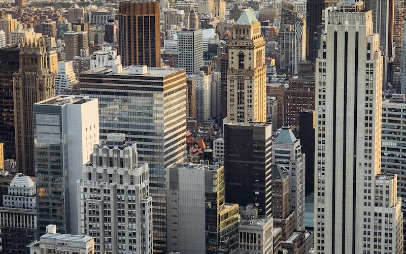 From above of downtown of megapolis with high rise financial and residential buildings located in New York City in daytime
